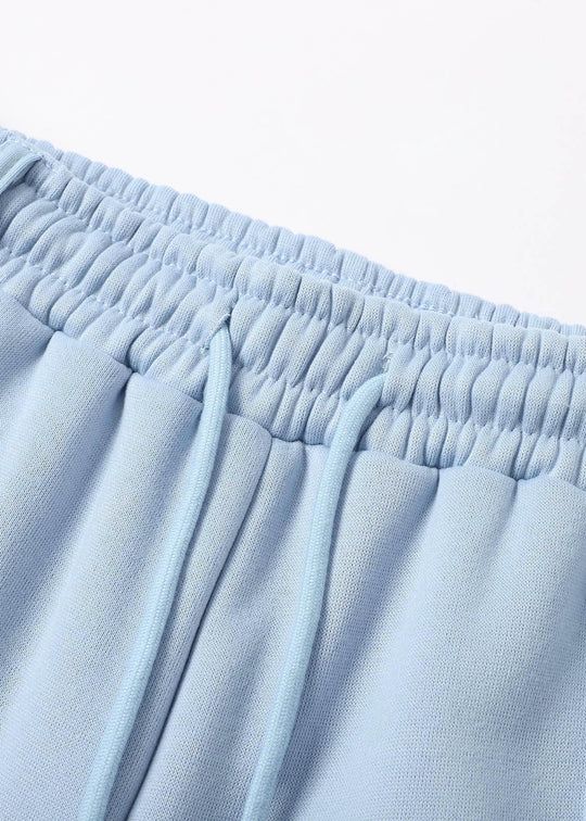 Close-up of light blue pants with an elastic waistband on a white background
