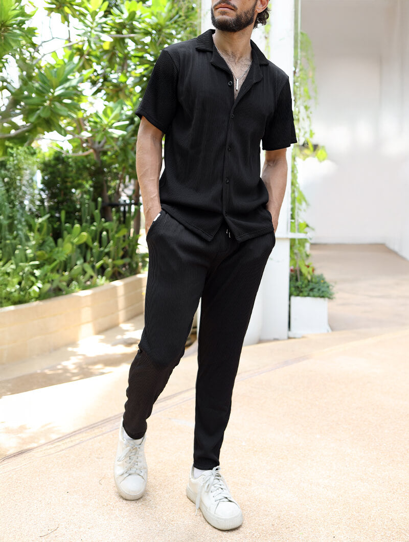 Person wearing a Balinaro Bailey black outfit with white sneakers in an outdoor setting