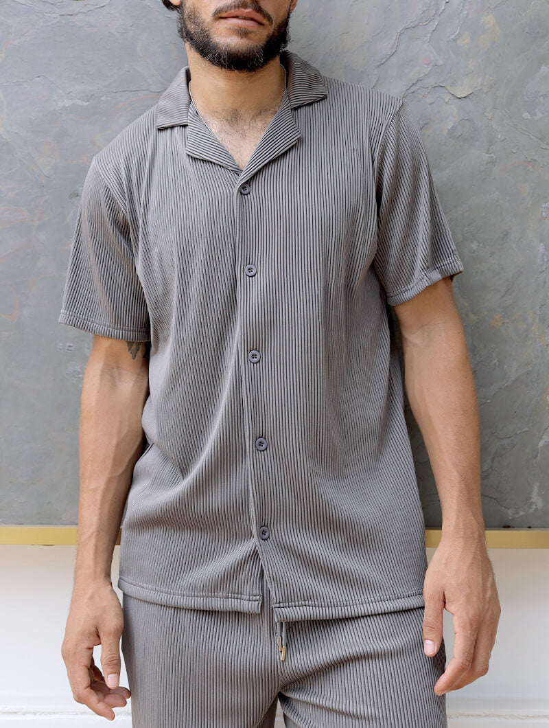 Person wearing a Balinaro Bailey gray striped  set against a gray background